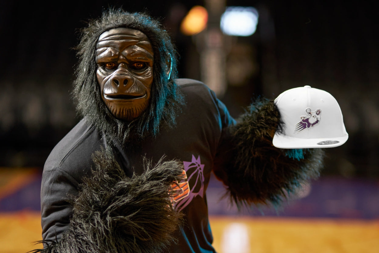 Suns mascot holding hat