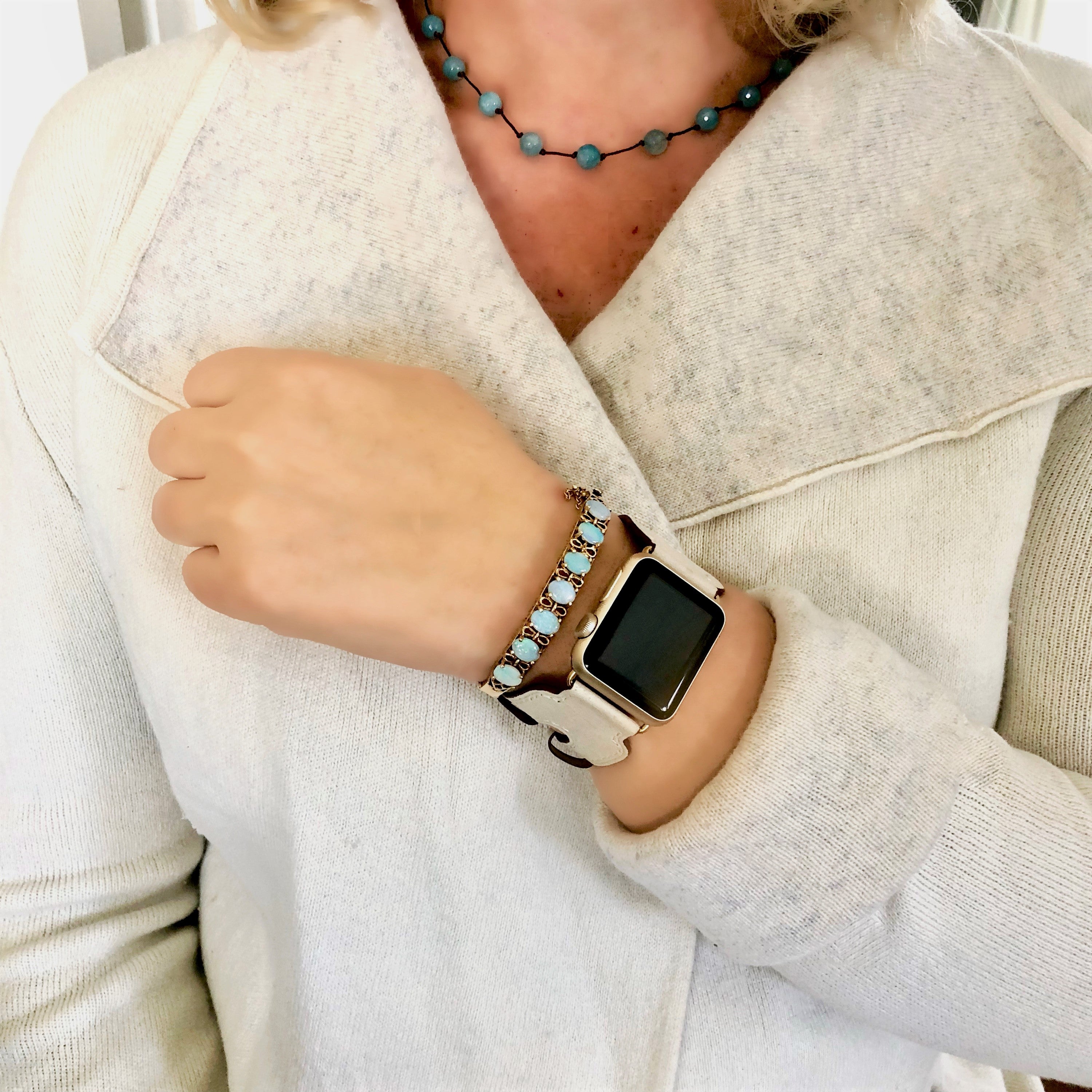 Juxli Home Ivory Double Buckle Leather Apple Watch Cuff on Woman Wearing Ivory Sweater