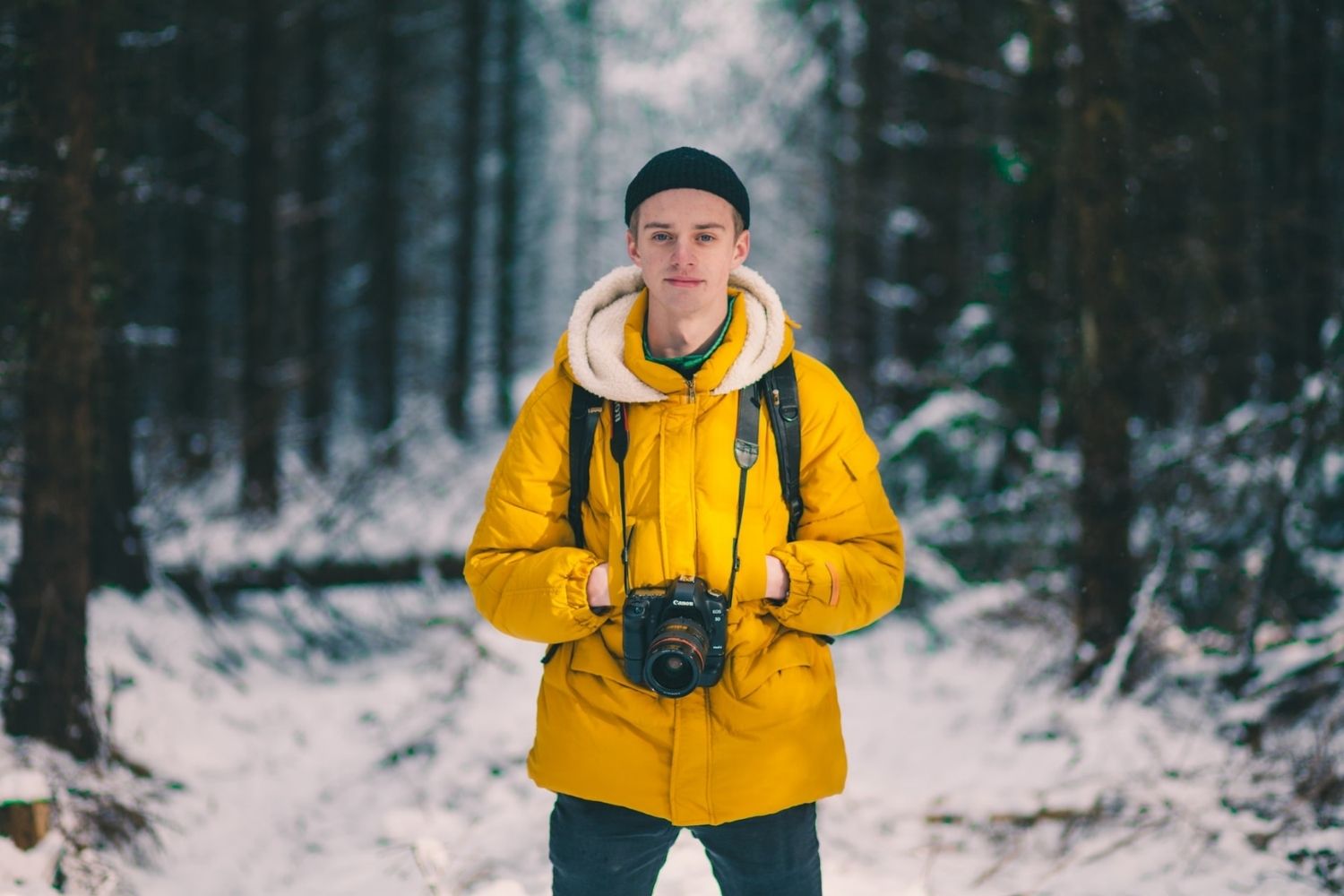 photo of a man holding camera in the forest