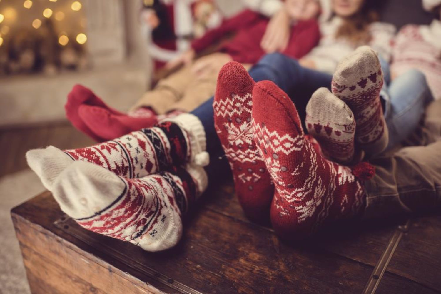 photo of family wearing Christmas socks on bed
