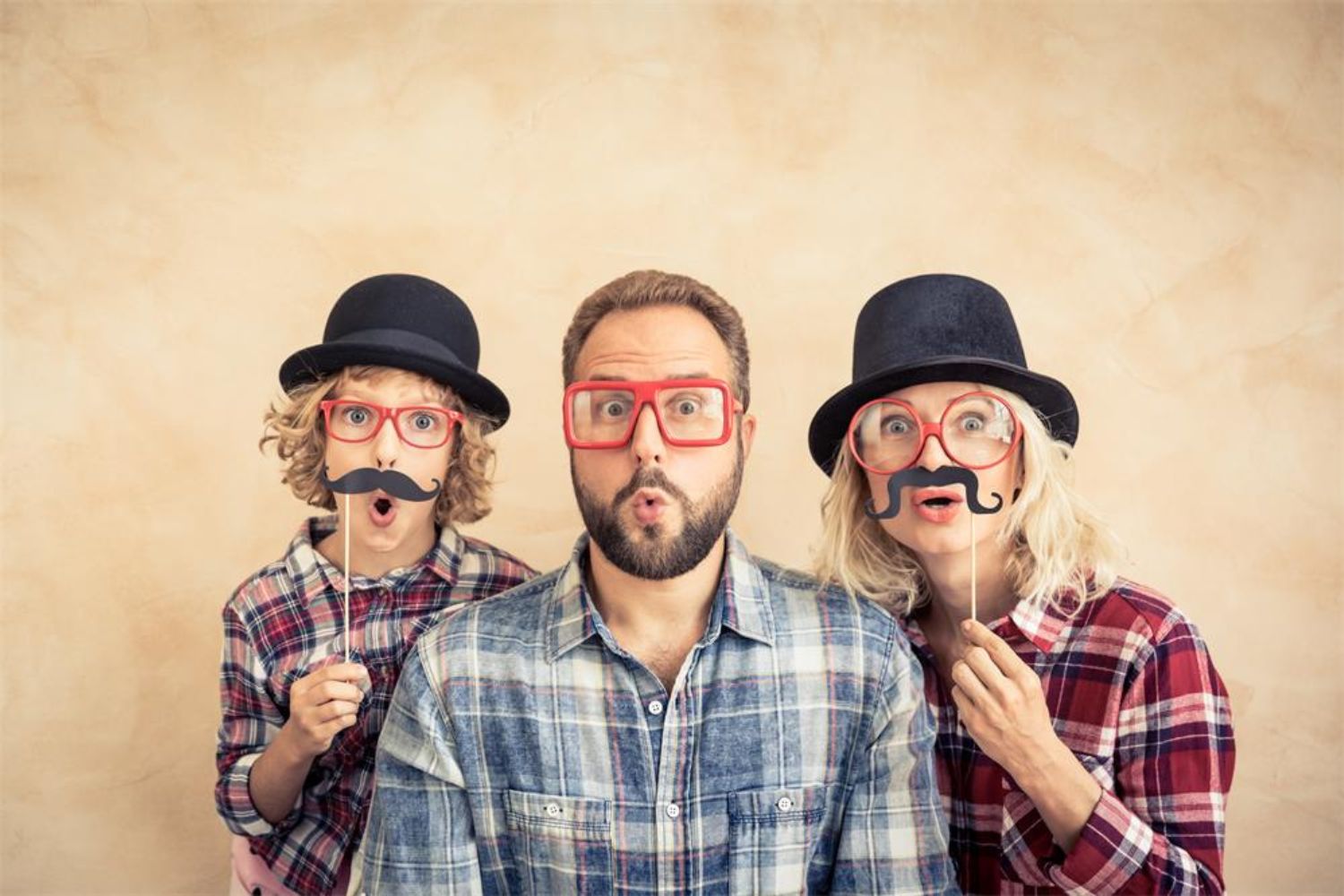 parents and kid wearing funny glasses