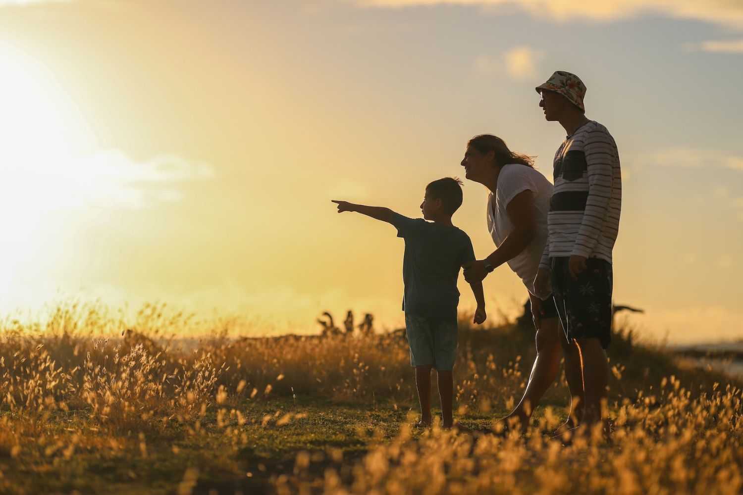 family looking into far away in the golden sunset