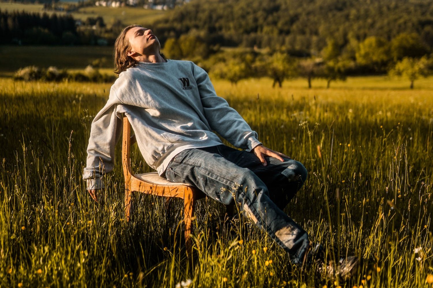 a man is taking a sitting photo by upholding his Jawline