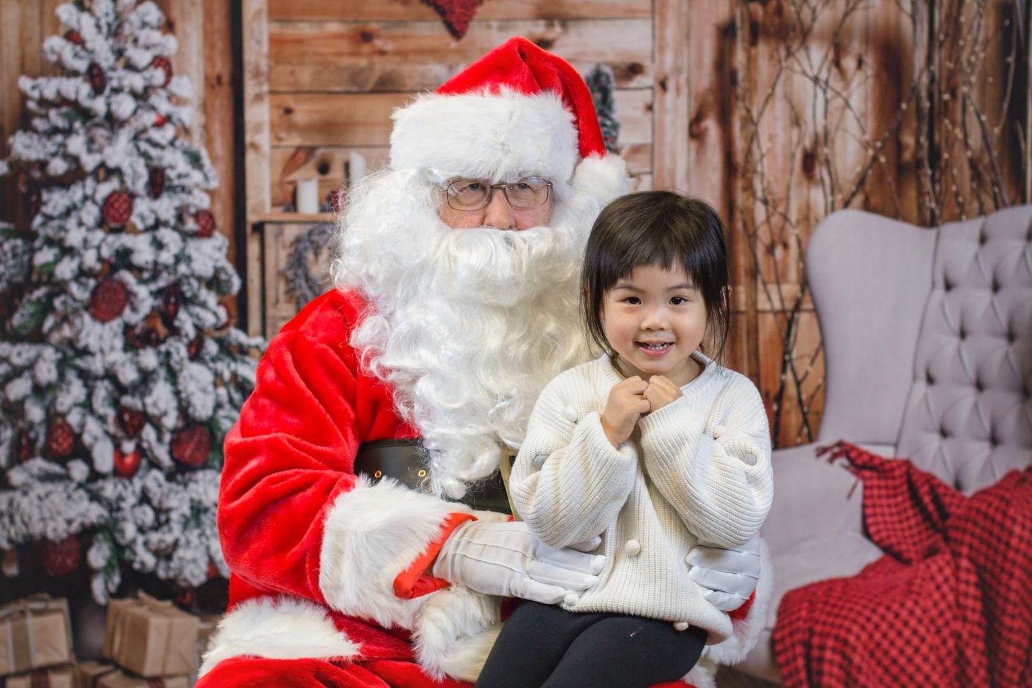 a little girl sitting on Santa's lap