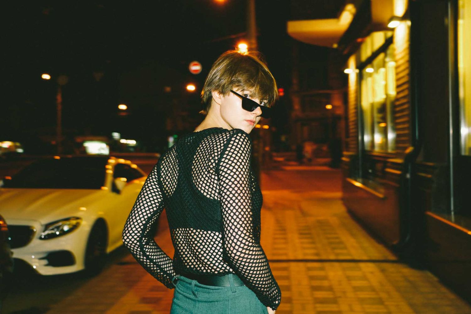 fashion girl looking back at night street