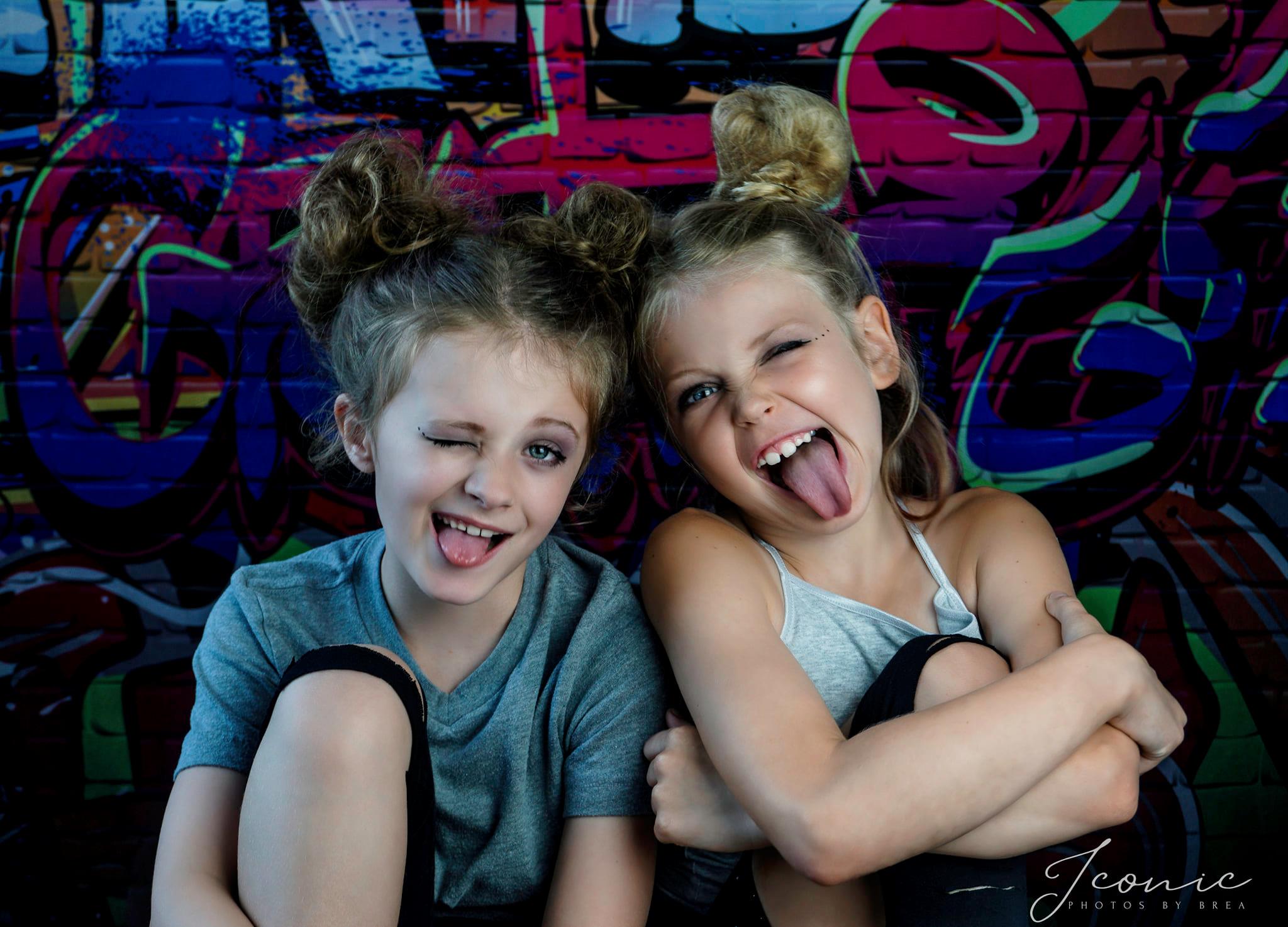 Two cute girls are making faces to show their naughty