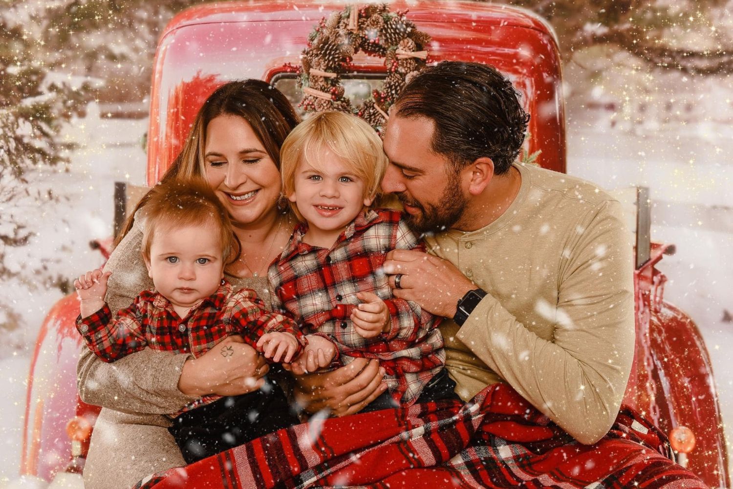 family snuggling together in truck bed