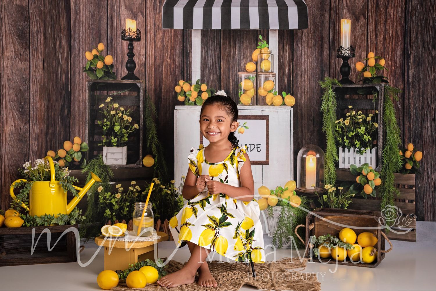a little girl taking photo with lemon decorations