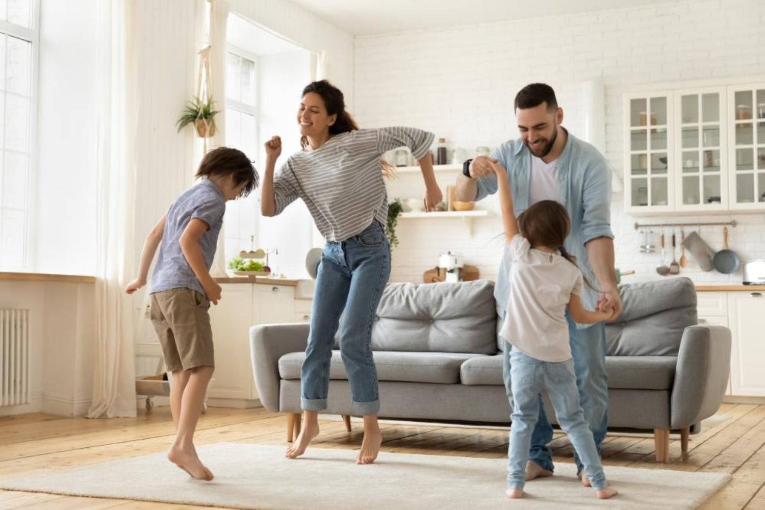 parents and kids dancing in the living room