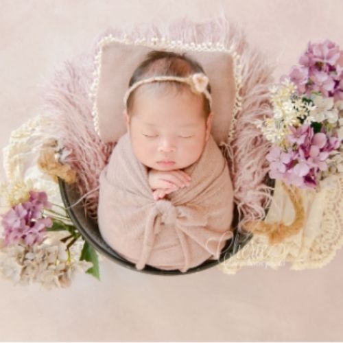 baby's photo with a pink backdrop