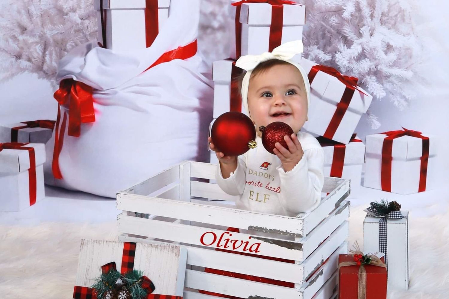 baby's Christmas photo with gift boxes