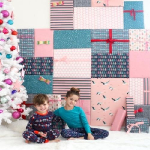 kids taking photo in front of Wrapping Paper Backdrop