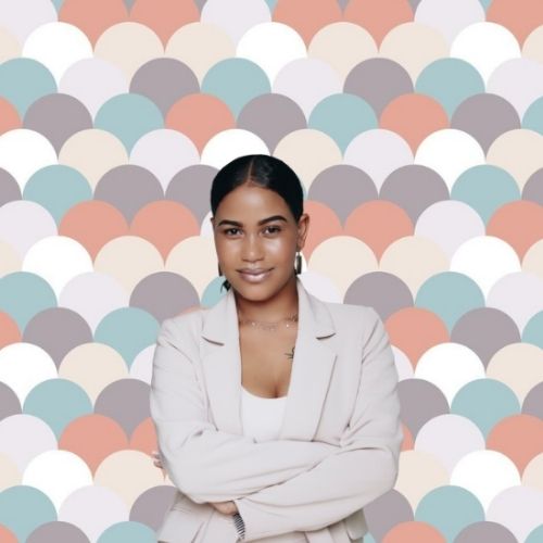 a photo of a woman in front of Scalloped Paper DIY Backdrop