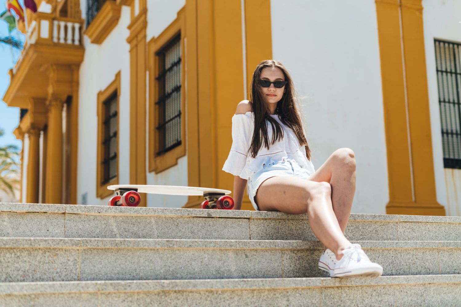 a woman is taking a sitting photo with one leg extended