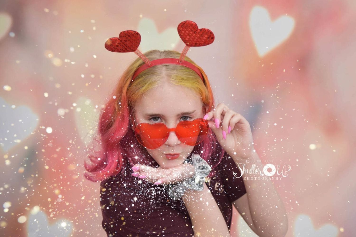 a young girl's portrait with bokeh heart-shaped light