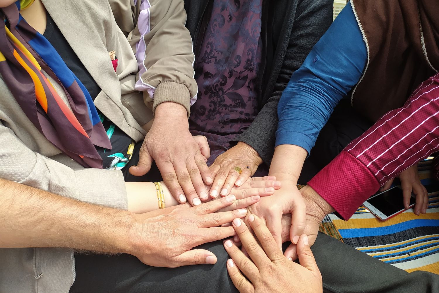 family members putting their hands together