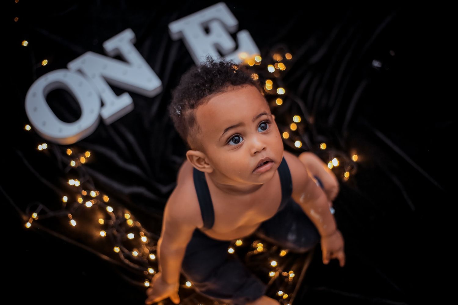 baby boy's first yeas birthday with string lights