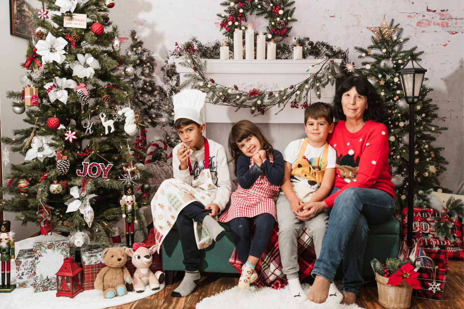 mother and kids taking photo with Christams tree and gift boxes