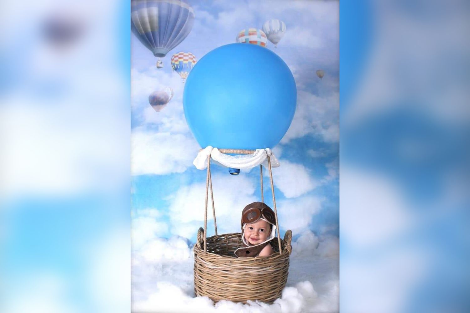 baby boy sitting in hot air balloon