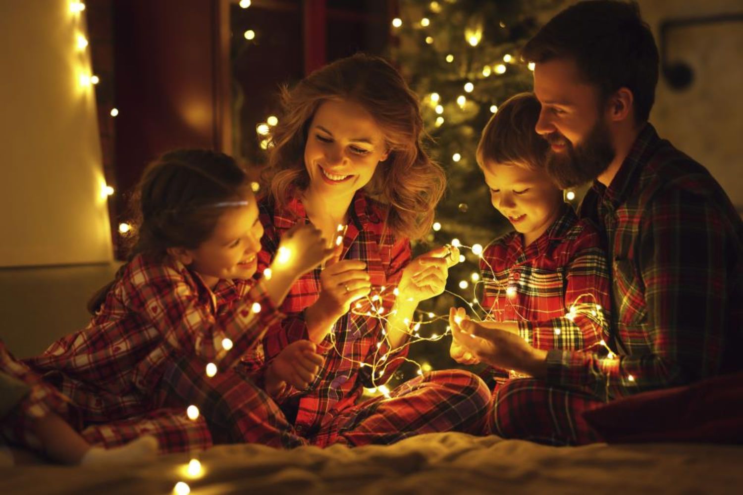 kids playing lighting with parents in pajamas