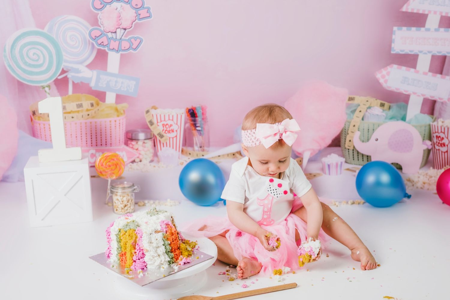baby girl's cake smash with pink backdrop