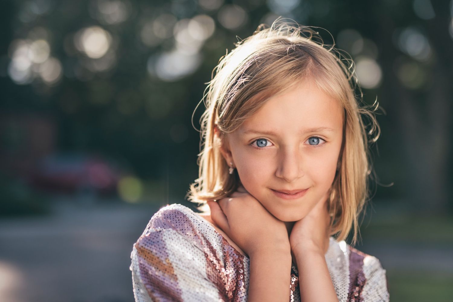 little girl taking photo by resting her chin on hands