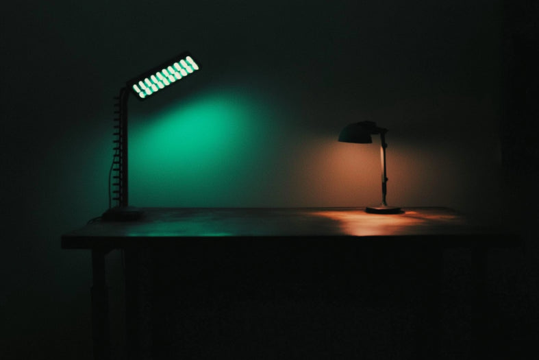 There is an LED desk lamp and a regular desk lamp on the desktop