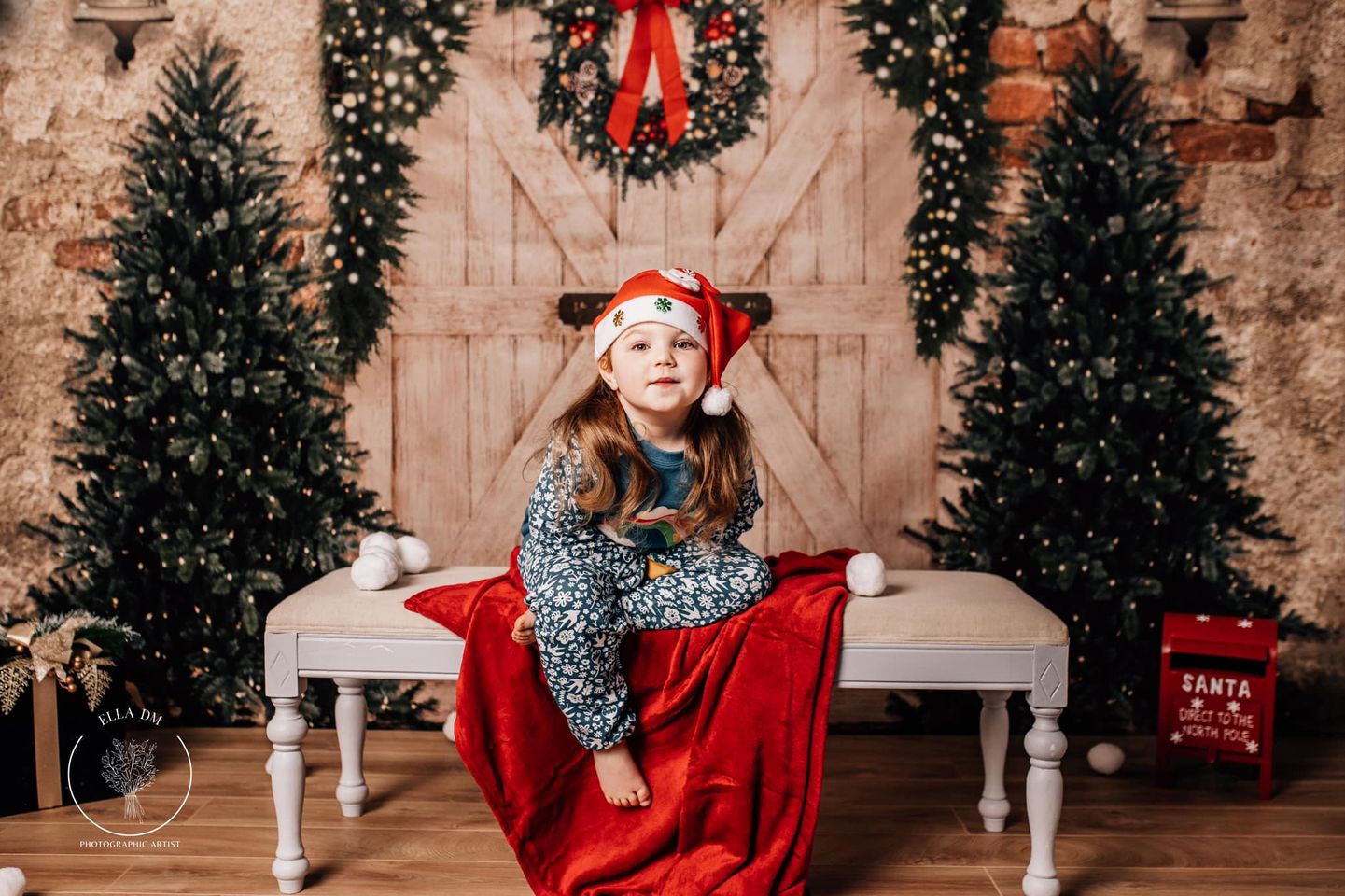 photo of little girl wearing Christmas hats with Kate Christmas Backdrop Brick Wall Door & Xmas Trees Designed By JS Photography