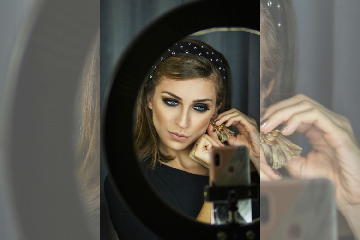 a selfie photo of a girl sitting in front of a mirror