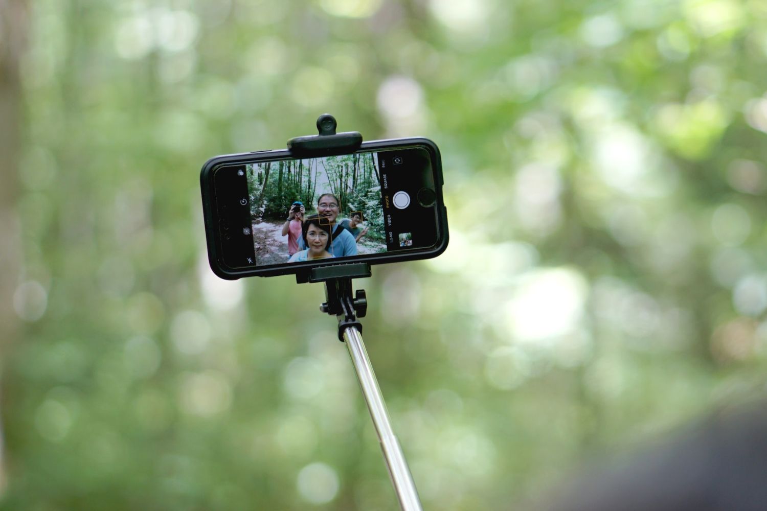 family photo on the phone taking by a selfie stick