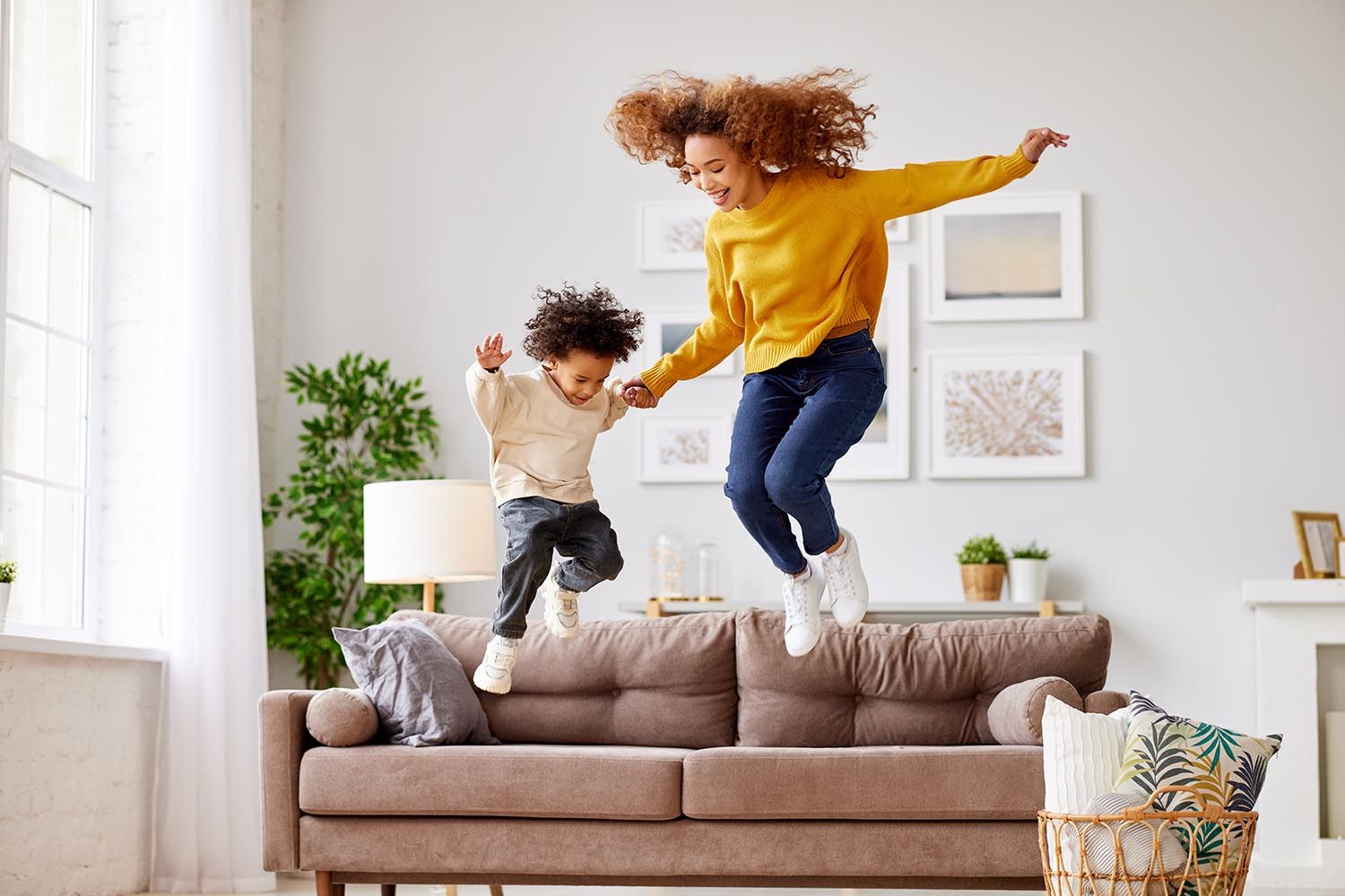 mom and son jumping in the living room