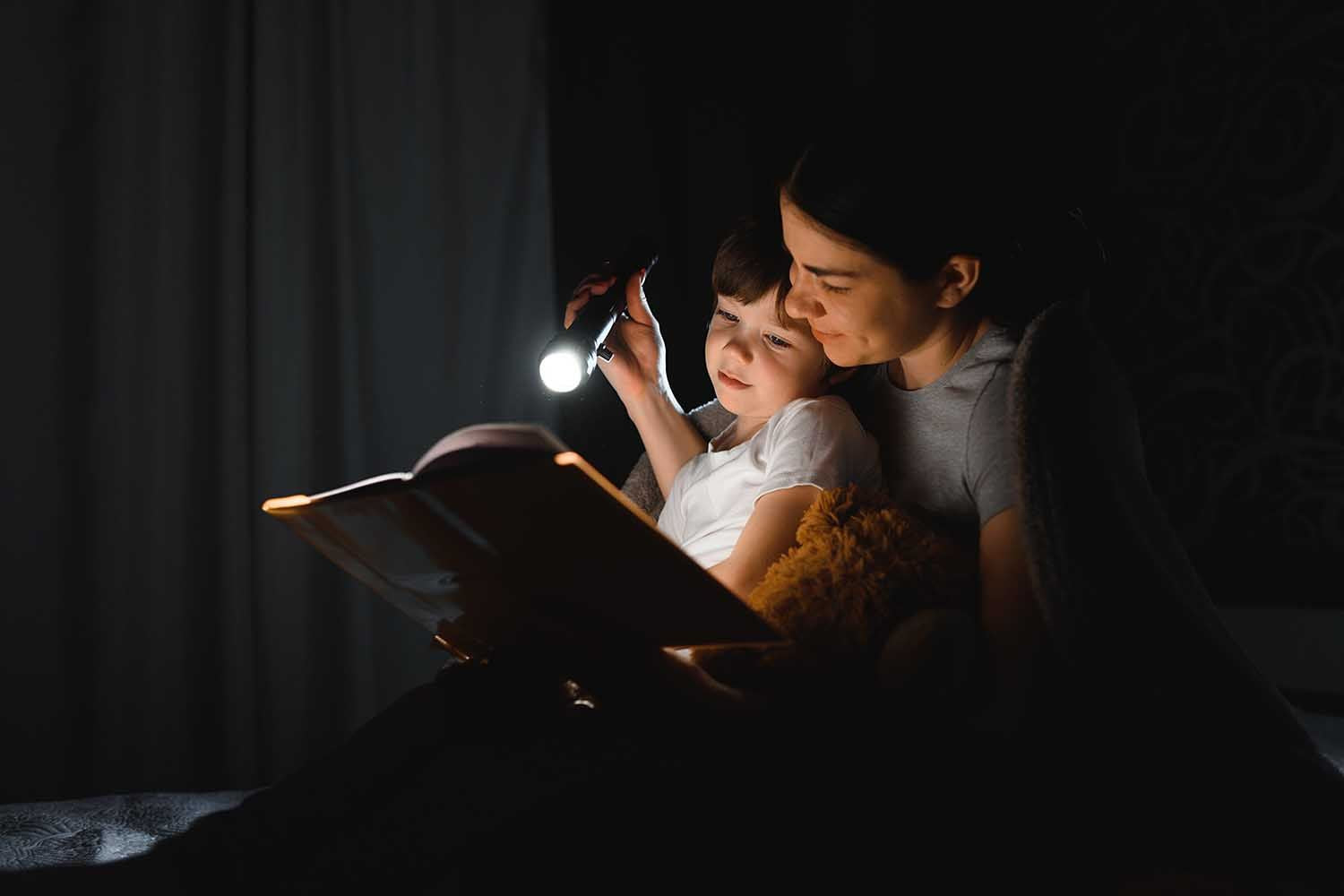 mom and son reading in bed