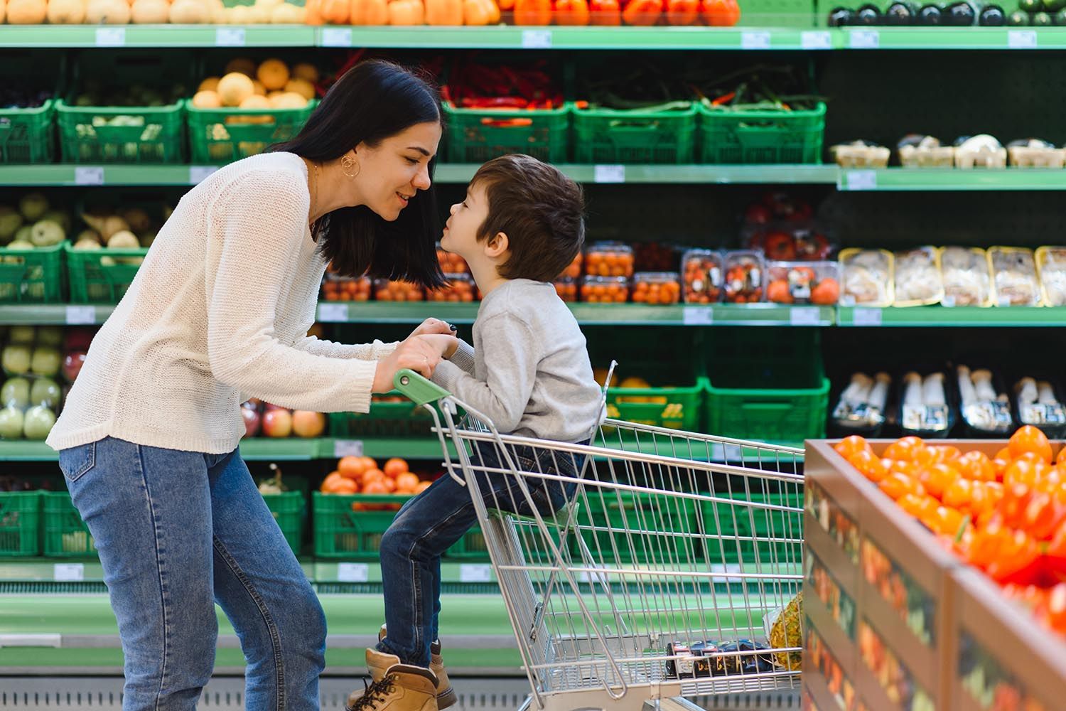 mom and son go shopping in the supermarket