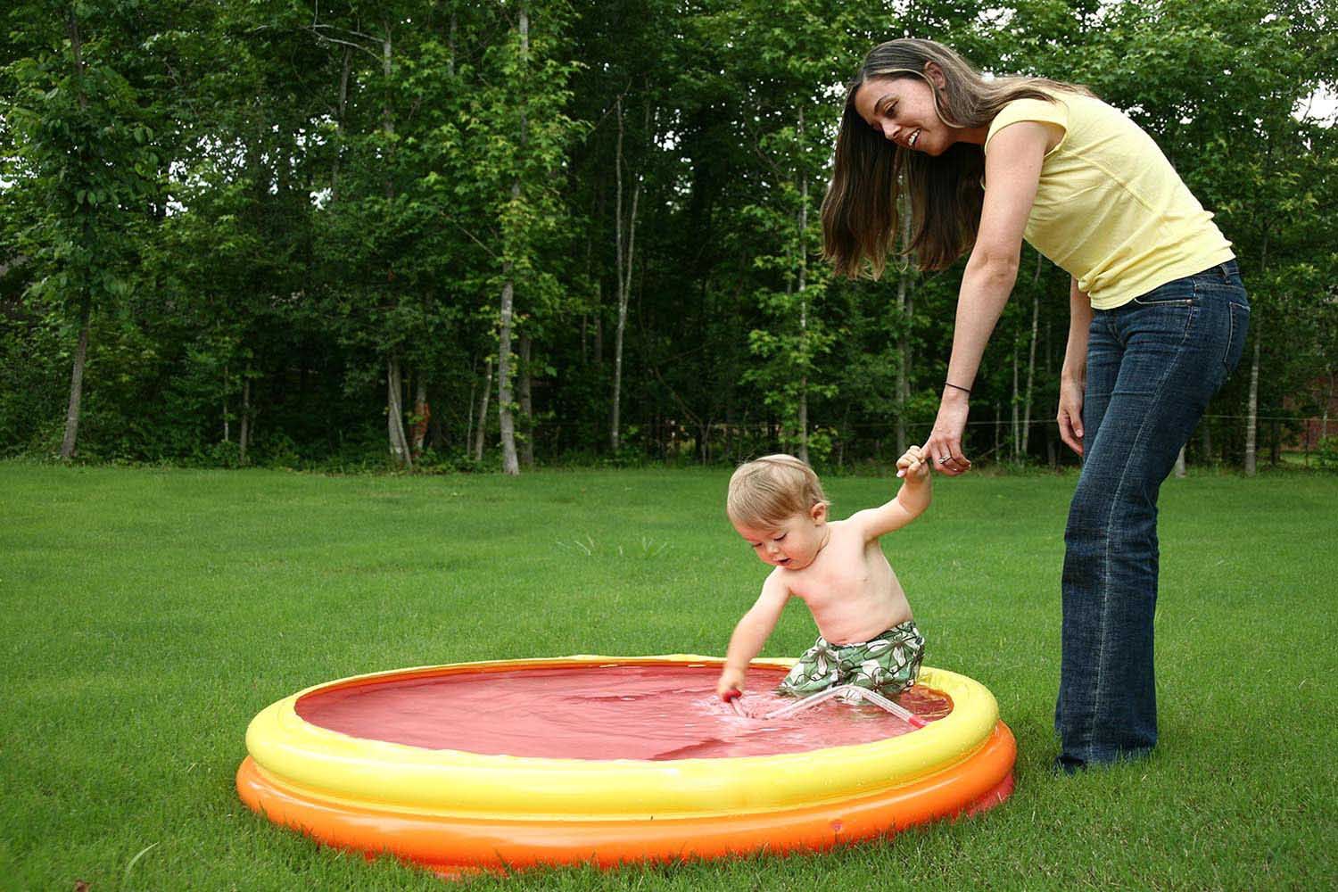 mom and son Splash Around in a Kiddie Pool