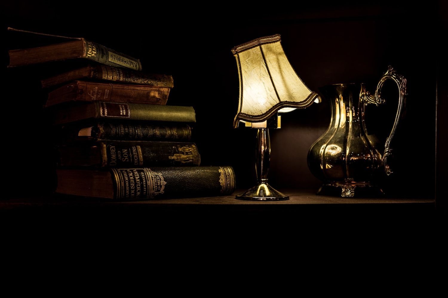 lighting ancient lamp on desk with books