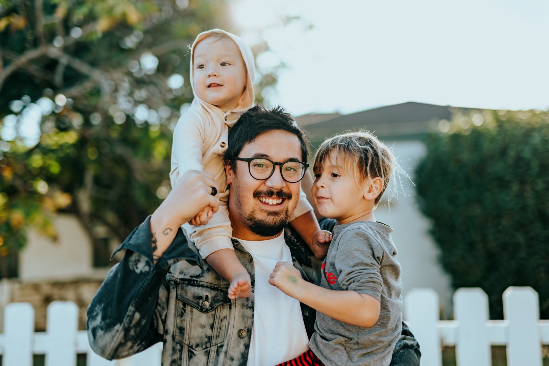 a Easter family picture of father holding two kids 