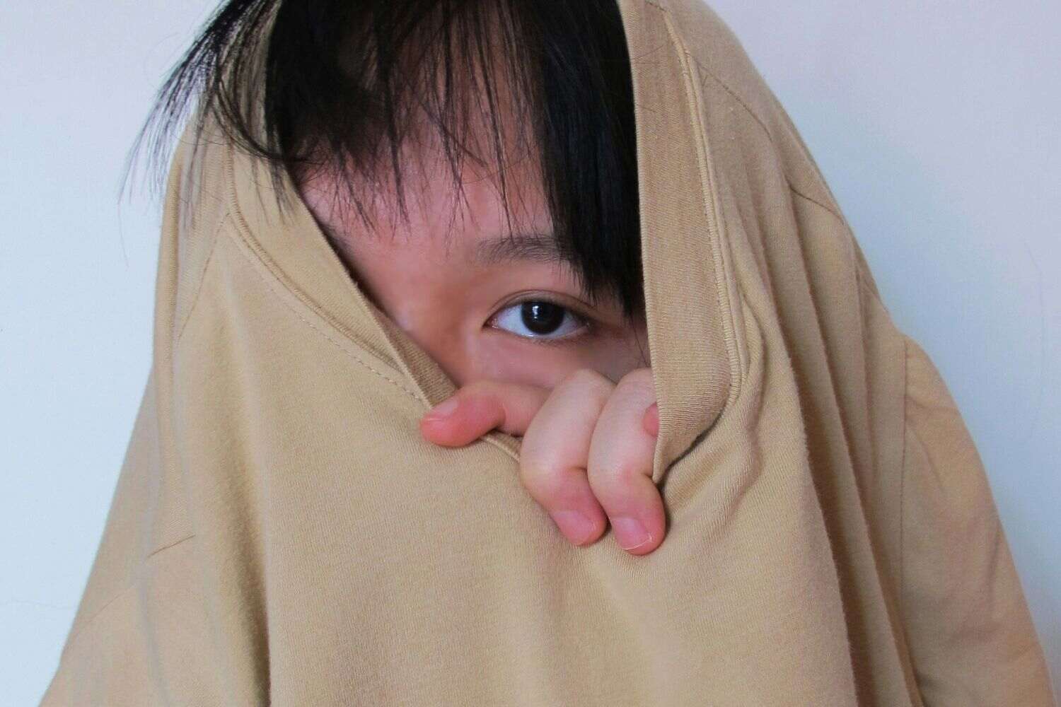 a photo of a girl hiding in a cute sweater tug