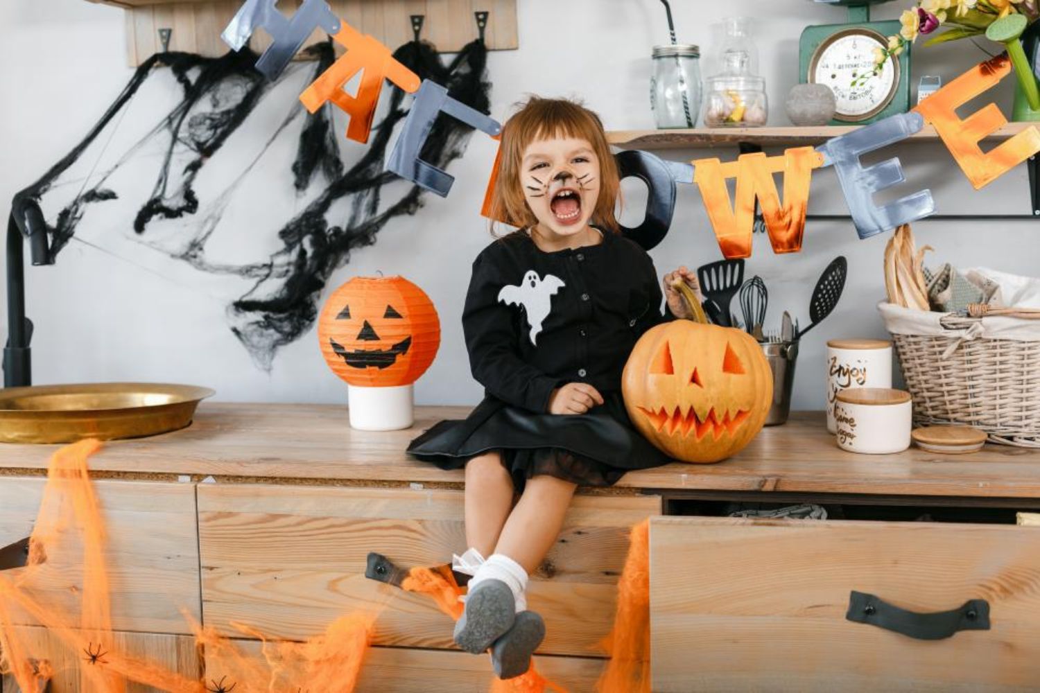 little girl's Halloween photo with curved pumpkins