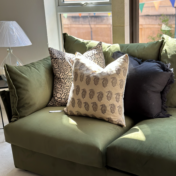 cushions on green sofa