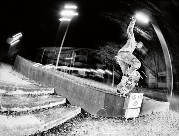 Martin Sandberg takes a frontside tailslide up and over the sign, shot by Gerard Riera