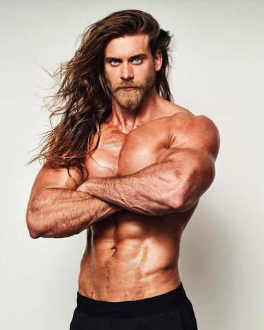 Brock O'Hurn topless with flowing hair on the beach 