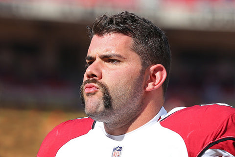 handlebar moustache on Justin Pugh red and white top