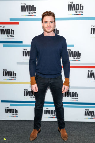Richard Madden shows his toned body in tight jeans and a jumper