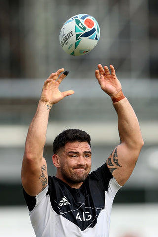 codie taylor muscles tattoos black top throwing ball