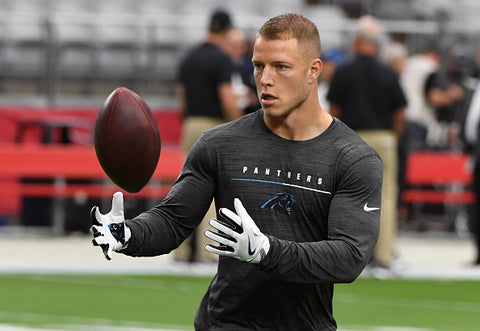 Christian McCaffrey black top catching ball