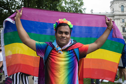 man in rainbow ride colours