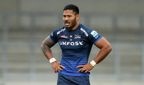 Manu Tuilagi  hands on hips blue top 