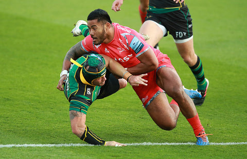 Manu Tuilagi in action on pitch red kit