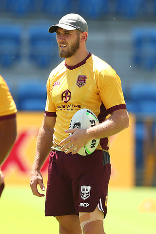 Kurt Capewell in yellow and burgundy rugby kit with rugby ball