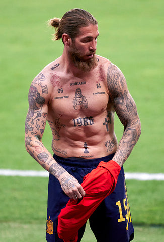 Sergio Ramos in navy shorts taking off red top body tattoos